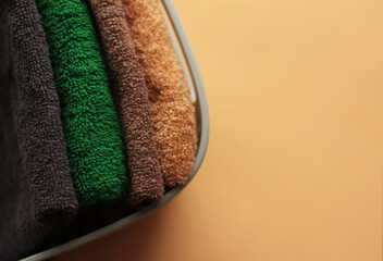 folded terry towels in the organizer on a peach fuzz color background