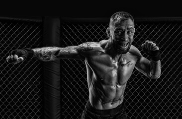 The dramatic black white image of the MMA fighter. Photography in a real octagon. Brutal fighter