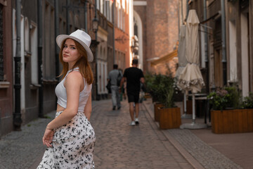 Fototapeta premium girl in a white hat on the background of the city of Gdansk Poland Europe