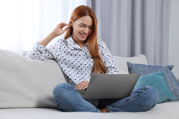 Woman having video chat via laptop at home