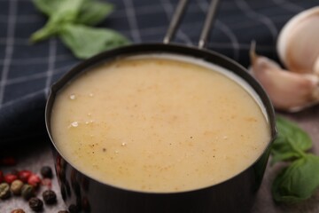 Delicious turkey gravy in saucepan on table, closeup