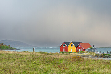 beautiful colored houses on the island Sommarøya, Troms, Norway, surrounded with with salt water...
