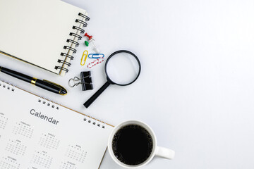 Top view of New Year's calendar page on desk office and to-do list notebook. Ideas for planning and working goals in the organization for starting the new year. with copy space