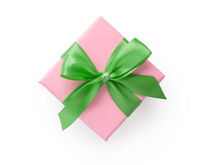 Top view of pink gift box with green ribbon bow isolated on white background