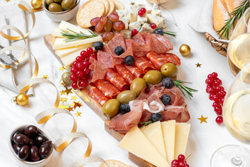 Party charcuterie board italian food antipasti prosciutto ham, salami and cheese appetizers served...