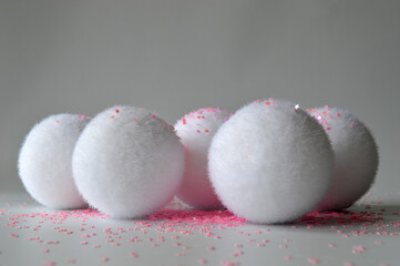 White fluffy snowballs covered by pink stars