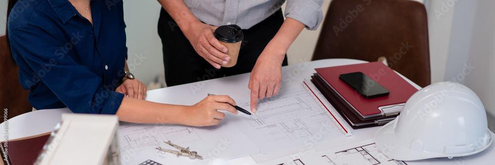 Aufkleber two architects pointing on blueprint to analysis and planning about construction building project