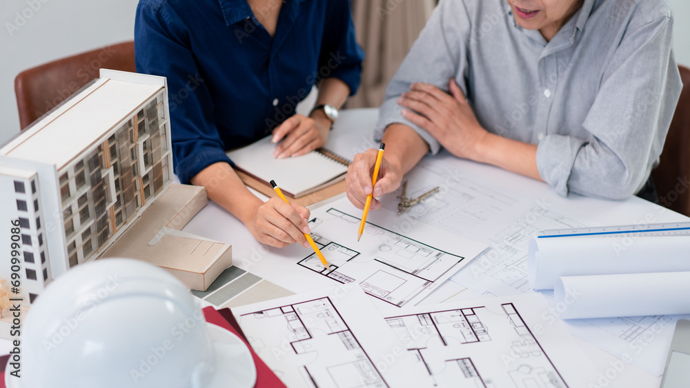 Poster two architects are analysis and planning about construction of building project on blueprint