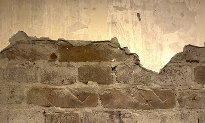 Fragment of an old wall with cracks and holes. Structure of an old wall. Architectural concept for repair, restoration and construction.