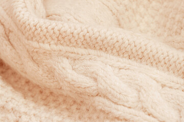 Fototapeta na wymiar Knitted texture of delicate peach color, delicate background for design