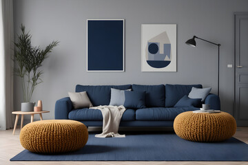A dark blue corner sofa next to knitted puffs. Interior design of a modern living room in the Scandinavian style.