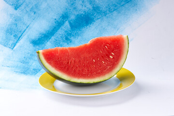 Cut watermelon on blue background.