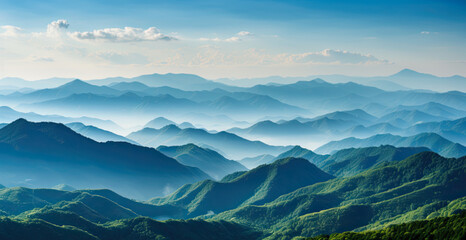 Fototapeta premium the mountains are shown in a blue sky and soft mist
