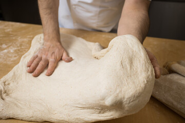 A baker prepares bread for baking