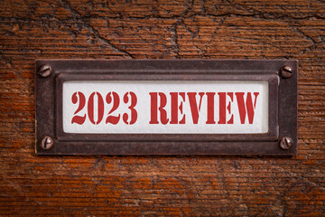 2023 review - a label on grunge wooden file cabinet. A passing year evaluation, summary and review concept. - obrazy, fototapety, plakaty