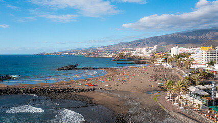 Aerial photo from drone to de Tenerife and beachs Adeje Playa de las Americas, Playa Honda,Playa de Troya, Playa de El Bobo.In the background Tenerife at sunset. Tenerife, Canary islands, Spain © Sandis