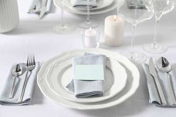 Beautiful table setting with blank card and candles