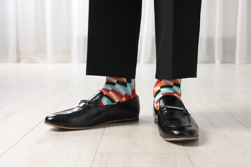 Man in stylish colorful socks, shoes and pants indoors, closeup - obrazy, fototapety, plakaty