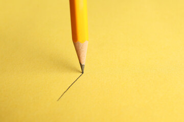One sharp graphite pencil drawing on yellow background, closeup. Space for text