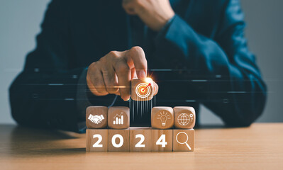 Businessman setup business trend 2024 strategy action target, Start calendar 2024 plan concept. Person Goal challenge person planning growth New year 2024, profit income, digital marketing. - obrazy, fototapety, plakaty
