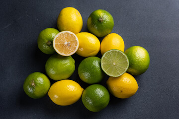 Limes and lemons on a dark background, close-up