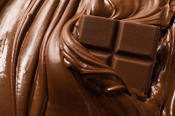 Tasty milk chocolate paste and pieces as background, closeup
