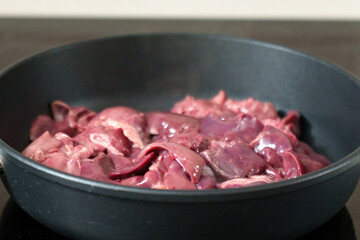 Cooking chicken liver in a frying pan in close-up. Flavors and Juicy Tenderness. Selective focus