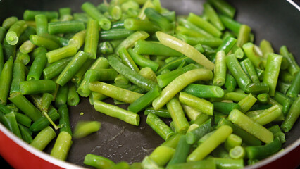 Green Beans Sizzling in Pan, Creating a Mouthwatering Dish. Selective focus
