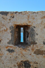 Fototapeta premium Close up of a Arrow Slit on the Fortified walls of Spinalonga Island, Crete, Greece. Europe.