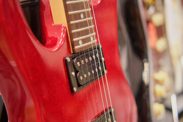 Red electric guitar in the store. Close-up. Selective focus.