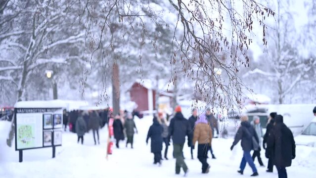 Snowfall at a festive Christmas market at winter time. Happy people walking to shops. Blurry back ground Copyspace 4k video.