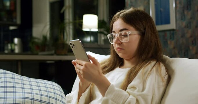 Teen girl student with smartphone can not do something on her smartphone, getting angry with funny facial expressions. Tapping and funny disapointed. Smartphone problem