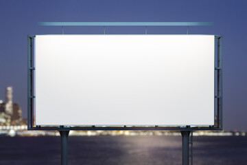 Obraz premium Blank white horizontal billboard on skyline background at evening, front view. Mock up, advertising concept