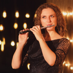 The female flautist, an accomplished musician, lit up the stage with her flute playing skills under...