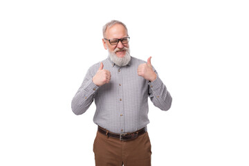 modern smart gray-haired mature businessman with a beard and mustache in a shirt and trousers on a...