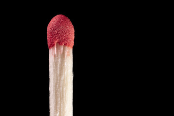 Wooden match with red sulfur head close-up