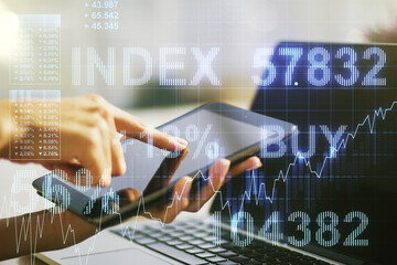 Multi exposure of abstract financial graph and hand working with a digital tablet on background,...