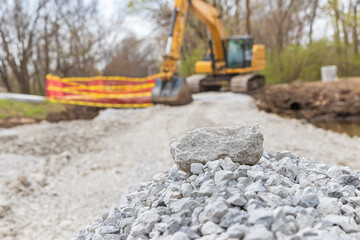 Pile of rocks on road construction site. Infrastructure improvement, repair and safety concept.