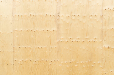 construction-grade plywood texture with knots