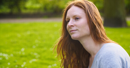 Young Redhead Woman in a Park