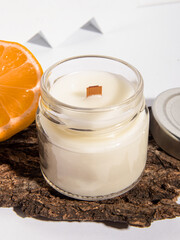 Handmade candle in a glass. Scented candle for home with citrus aroma. Wooden wick closeup