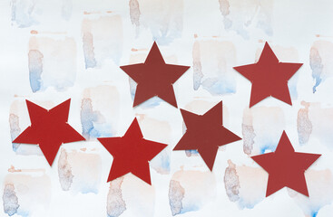 collection of red stars on paper with watercolor stains