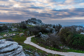 Landscape of a path between limestone stones shaped by erosion in El Torcal de Antequera, Malaga.