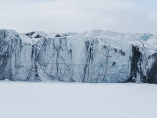 Glacier front with old blue and dirty black ice © Natalia