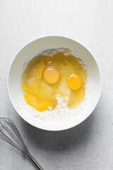 Creaming butter, sugar and egg with a wooden spoon, the process of making a cake, mixing butter, sugar and egg to make a cake
