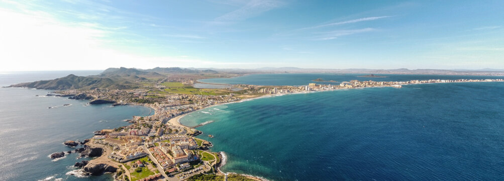 Aerial drone perspective of famous region La Manga, Murcia Province. Spain. "Cabo de Palos" - Cape Palos. La Manga city in background. Beautiful panorama of all region. European Travel Destination