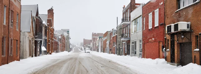 Gordijnen Panoramic view of a street in winter in an old neighborhood of Montreal  © Guy