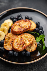 sweet breakfast French toast berrie, banana pancake fresh cooking meal food snack on the table copy space food background rustic top view