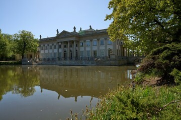Fototapeta na wymiar Pond and palace on isle in Warsaw city in Poland