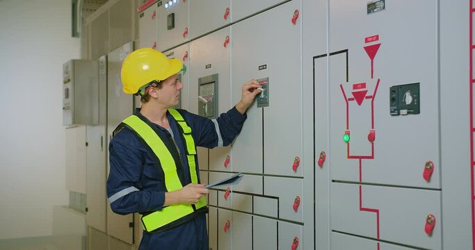 electricians electrical engineer in protective uniform wearing hard hat checking voltage control panel system at electrical cabinet for generate electricity of factory in manufacture industrial